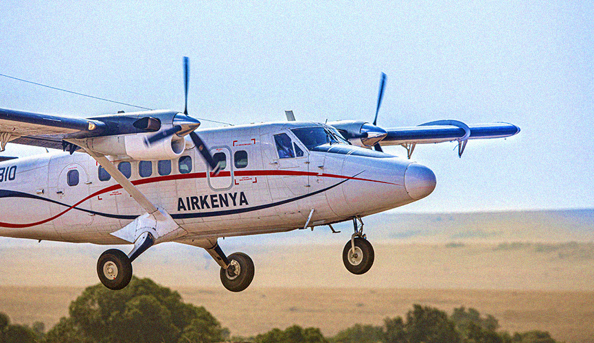 A light aircraft soars through the open sky on its way to the Maasai Mara